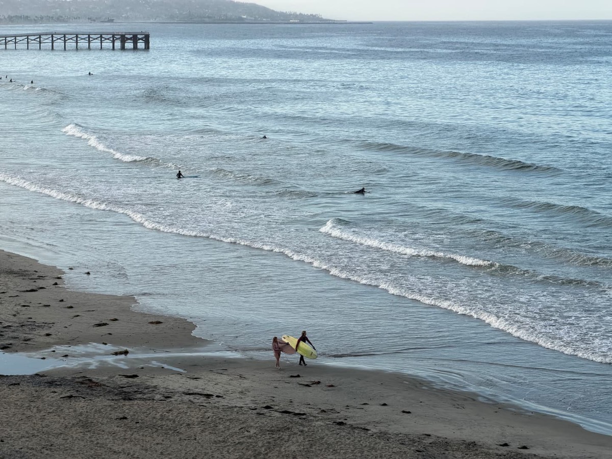 The beach and surf beside Crystal Pier, the view from the tables across the boardwalk