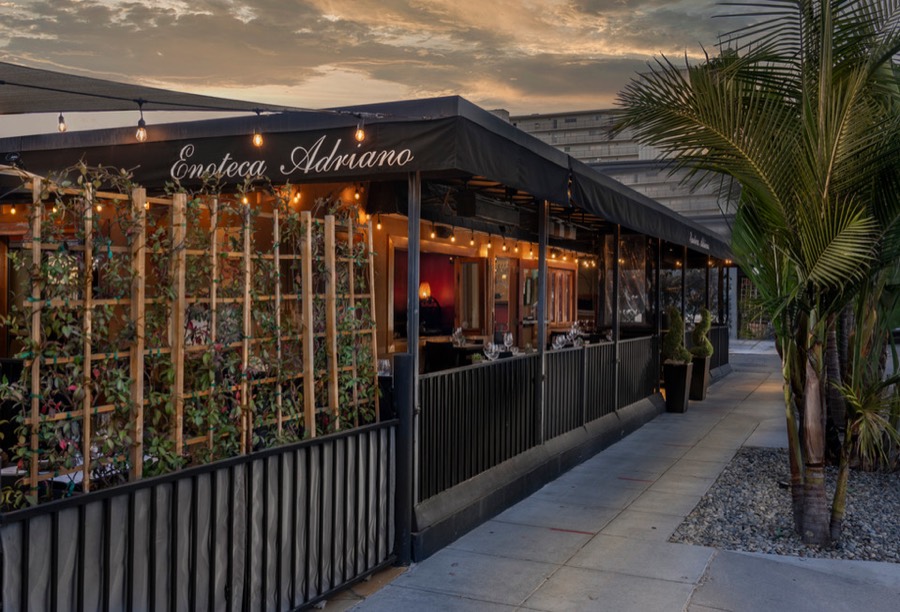 The string-lit patio outside Enoteca Adriano at dusk