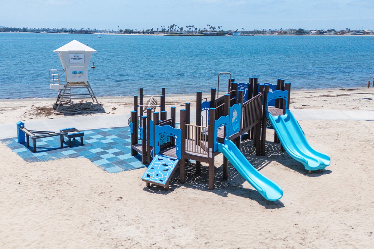 Slides and climbing frame at Fanuel Street Park, with the bay behind