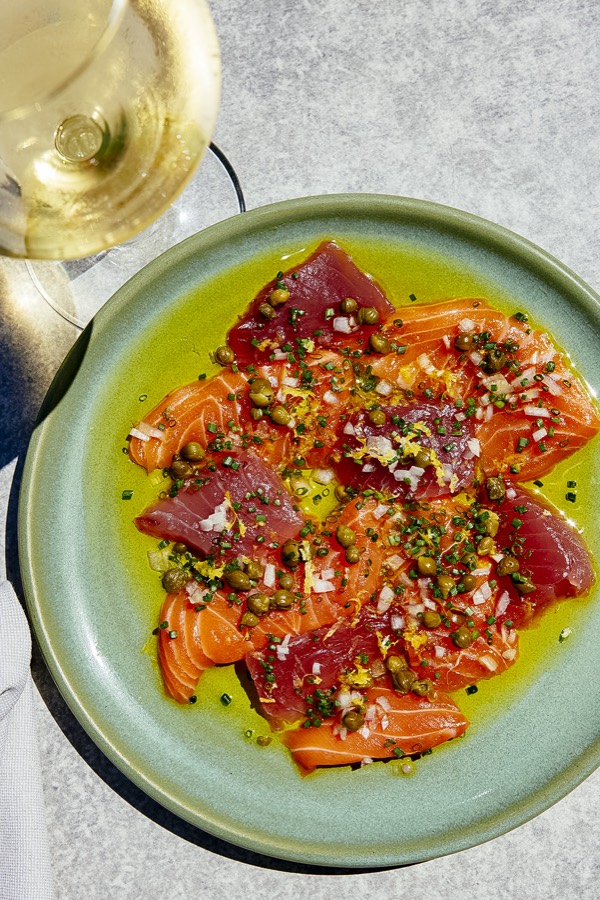 Tuna and salmon crudo with a glass of white wine at The Fishery