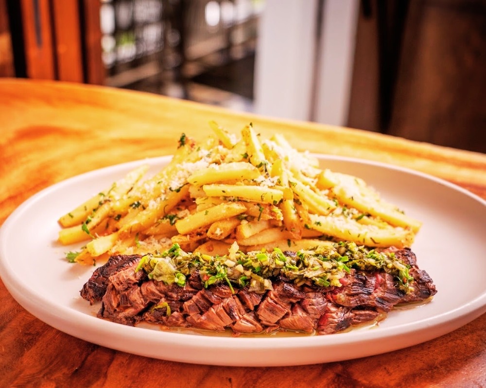 Steak frites plated at Hideaway Pacific Beach