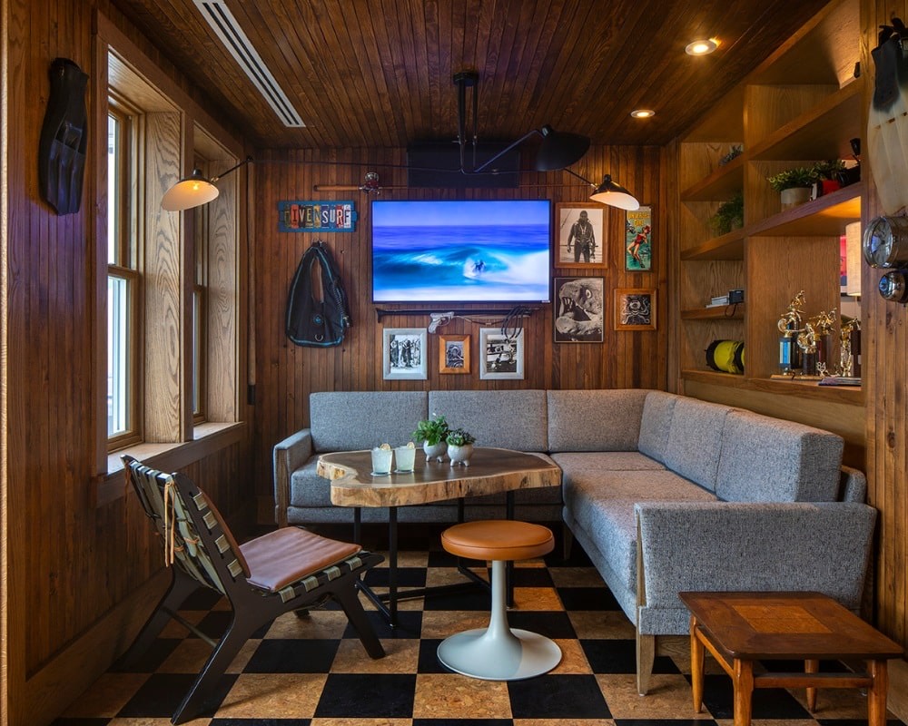 A booth with a wood ceiling and tiled floor inside Hideaway Pacific Beach