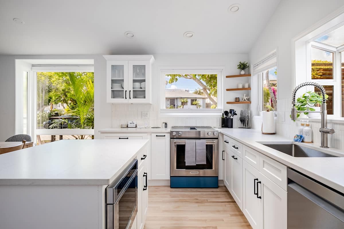 The kitchen, with a quartz island, open shelving and a blue range