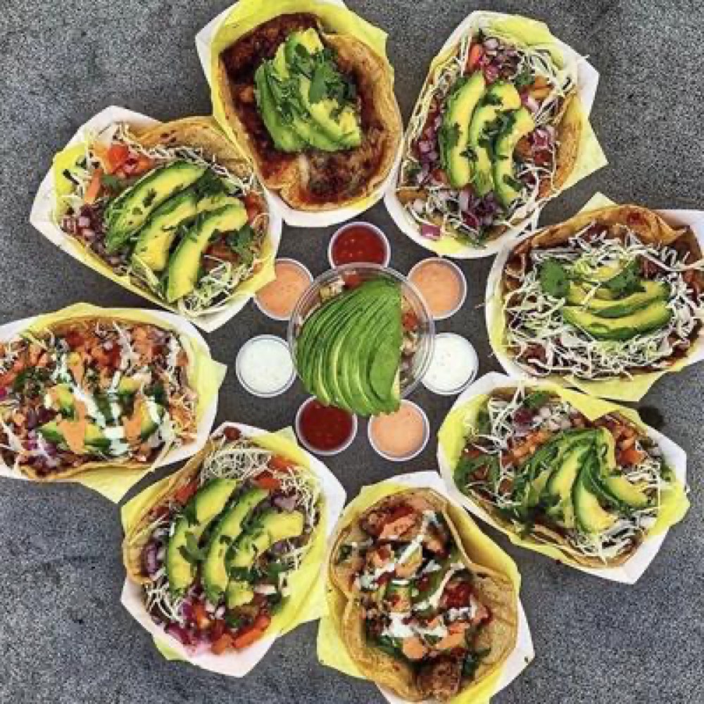 A spread of tacos, bowls and salsas from Oscar's Mexican Seafood