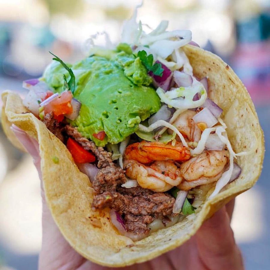 A shrimp taco piled with guacamole and cabbage at Oscar's Mexican Seafood