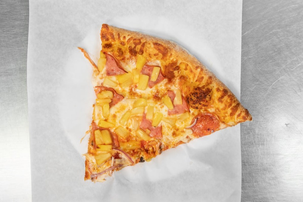A slice of Hawaiian pizza from Pizza Pal