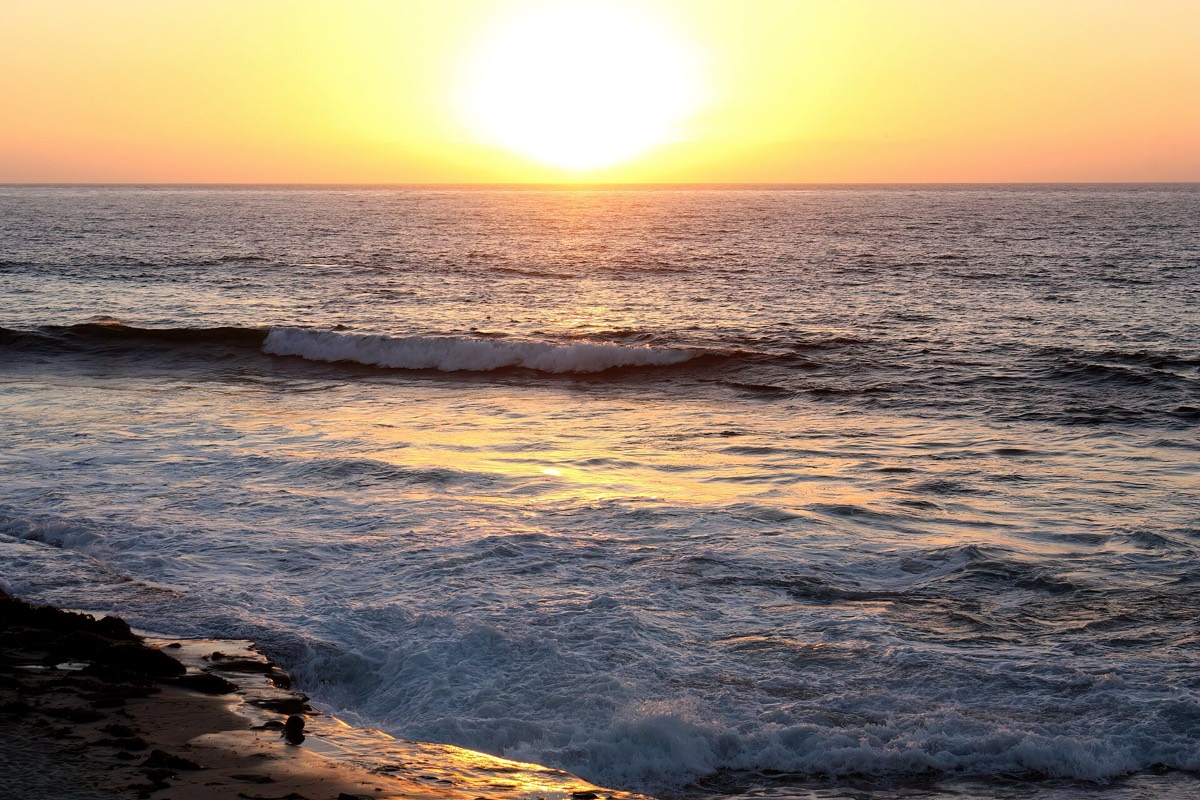 The sun going down over the water at Sunset Cliffs